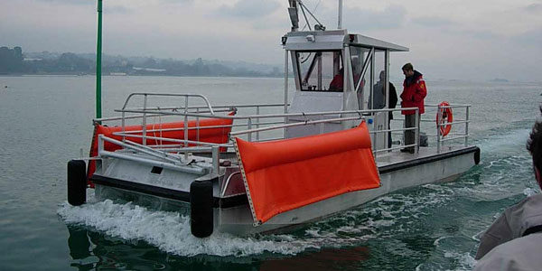 Boats cleaning water surfaces